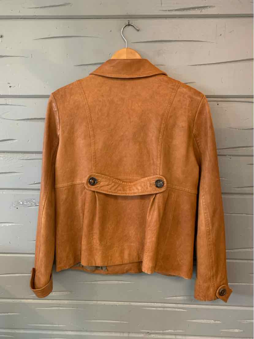 Tan suede Andrew Marc jacket with a cropped fit, pointed collar, buttoned back waist tab, and button cuffs.