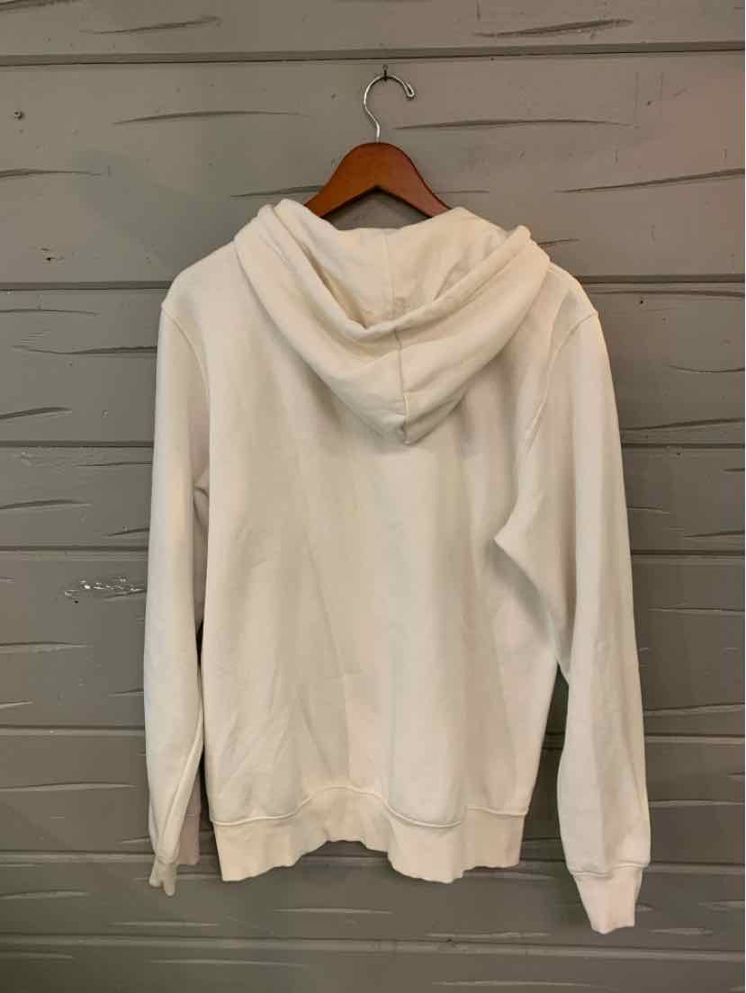 Creamy white hoodie with a relaxed fit, long sleeves, and a hood, hanging on a wooden hanger.