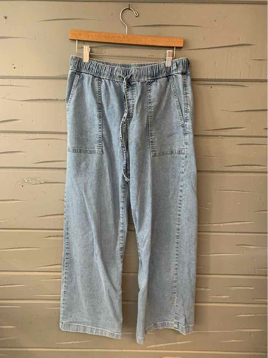 Light blue denim wide-leg pants with elastic waistband and front patch pockets.