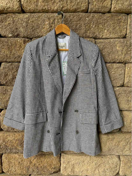 Black and white gingham blazer with notch lapels and double-breasted buttons in size small.