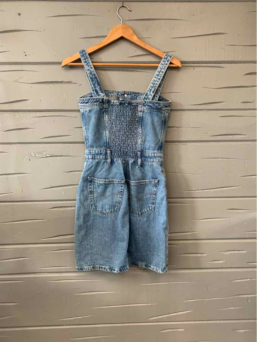 Blue denim sleeveless romper with adjustable straps and front pockets, size XS.