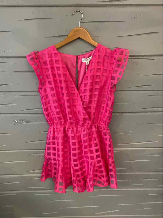 Pink short-sleeve romper with textured check pattern and elastic waist on wooden hanger.