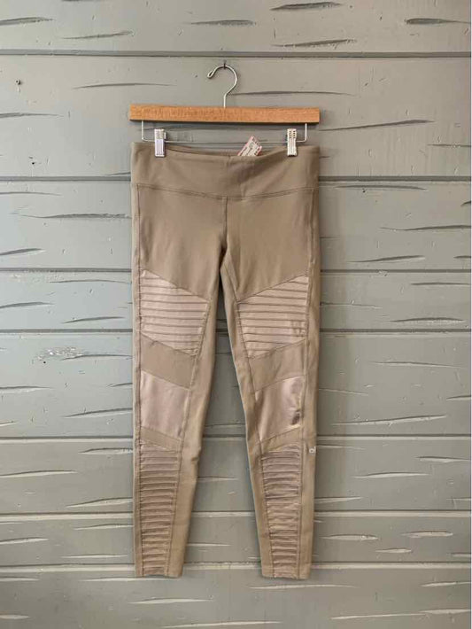 Taupe biker-style leggings with ribbed knee panels and zip ankle details hanging on wooden hanger.