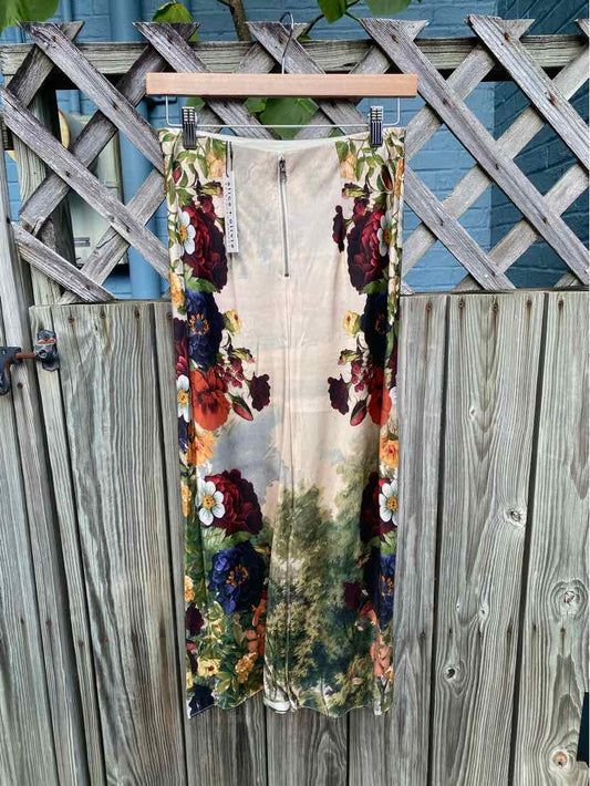 Sleeveless midi dress with floral print in red, purple, and green on white background, zipper front.