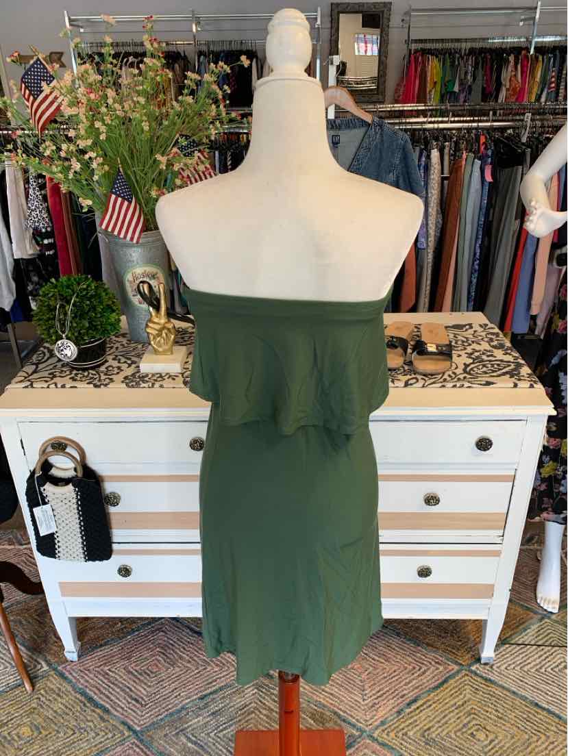 Olive green strapless dress with ruffled overlay and fitted silhouette on mannequin.