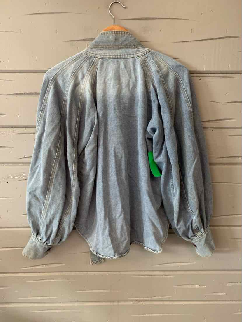 Light blue denim blouse with long puffed sleeves and gathered cuffs, loose fit.