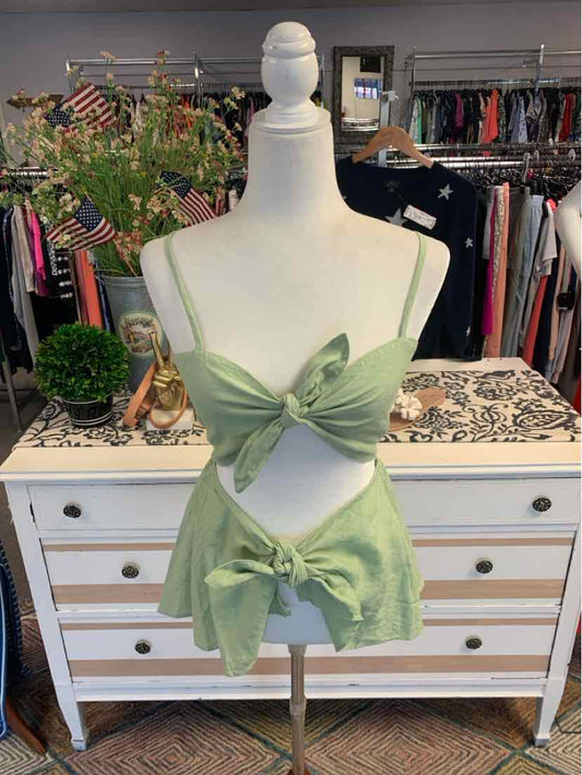 Light green knit crop top with front tie and matching high-waisted shorts on a mannequin.