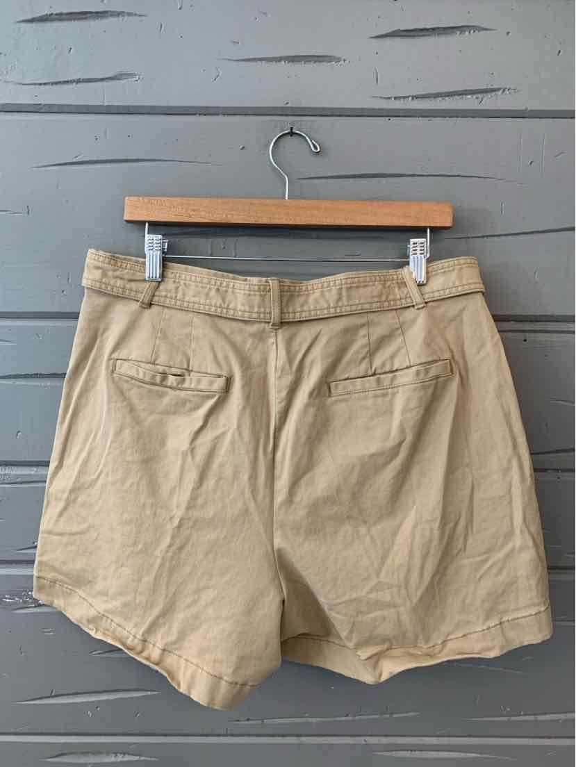 Khaki Banana Republic shorts size 14 with back welt pockets and belt loops on wooden hanger.