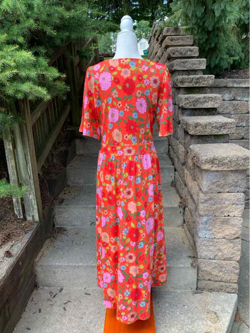 Red midi dress with orange, pink, and white floral print, short sleeves, and fitted waist.