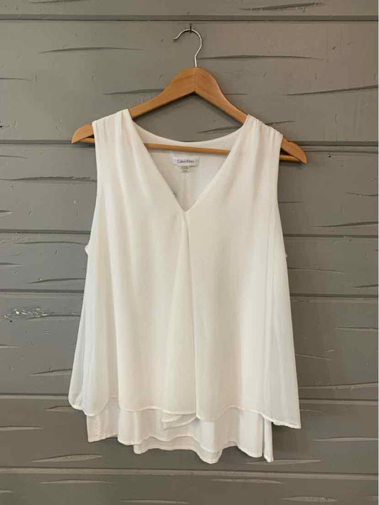 White sleeveless V-neck chiffon blouse with layered hem on wooden hanger.