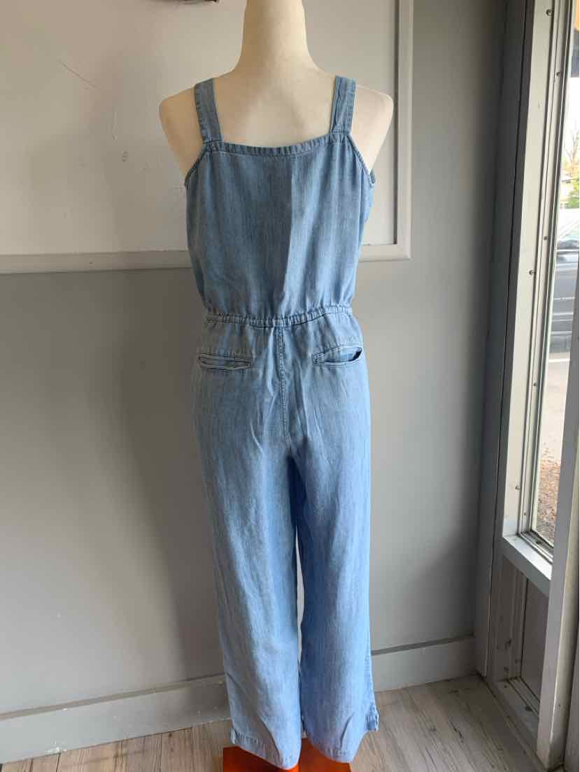 Light blue denim sleeveless jumpsuit with square neckline and straight-leg pants.