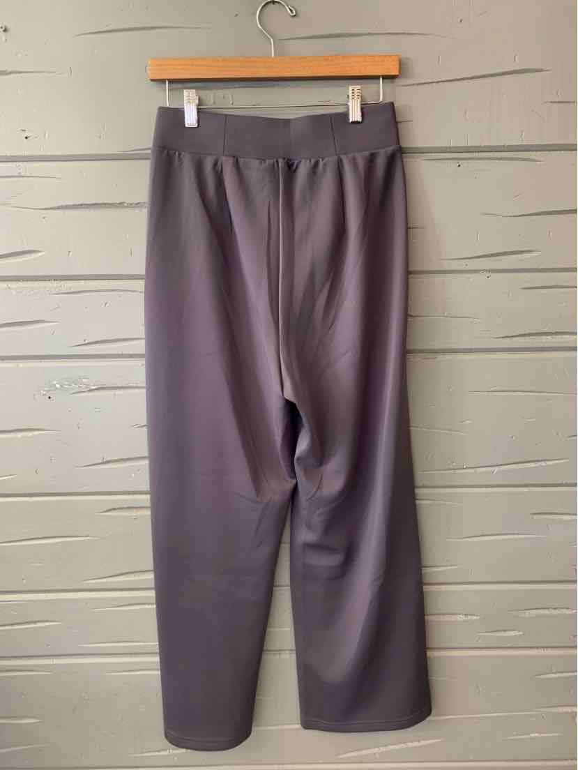 Gray Adidas women's solid elastic waist pants with wide legs hanging on wooden hanger.