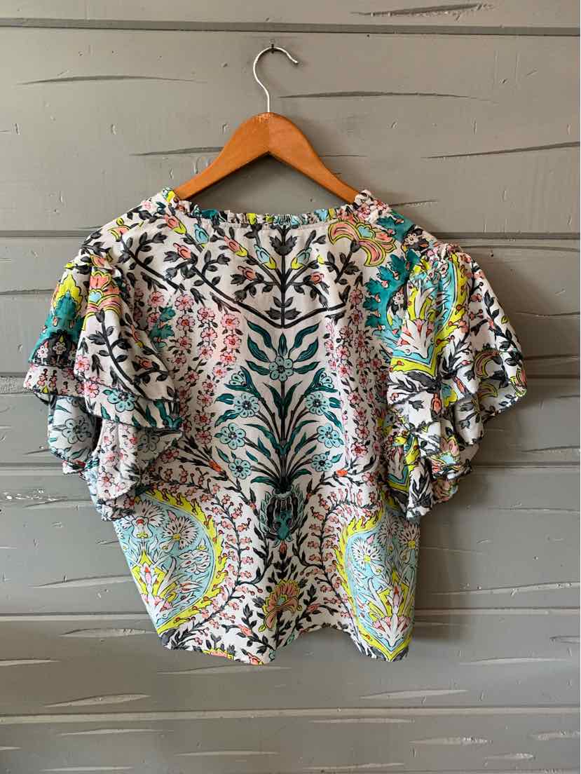 Short-sleeve floral blouse with ruffled sleeves in vibrant multicolor patterns on a light background.