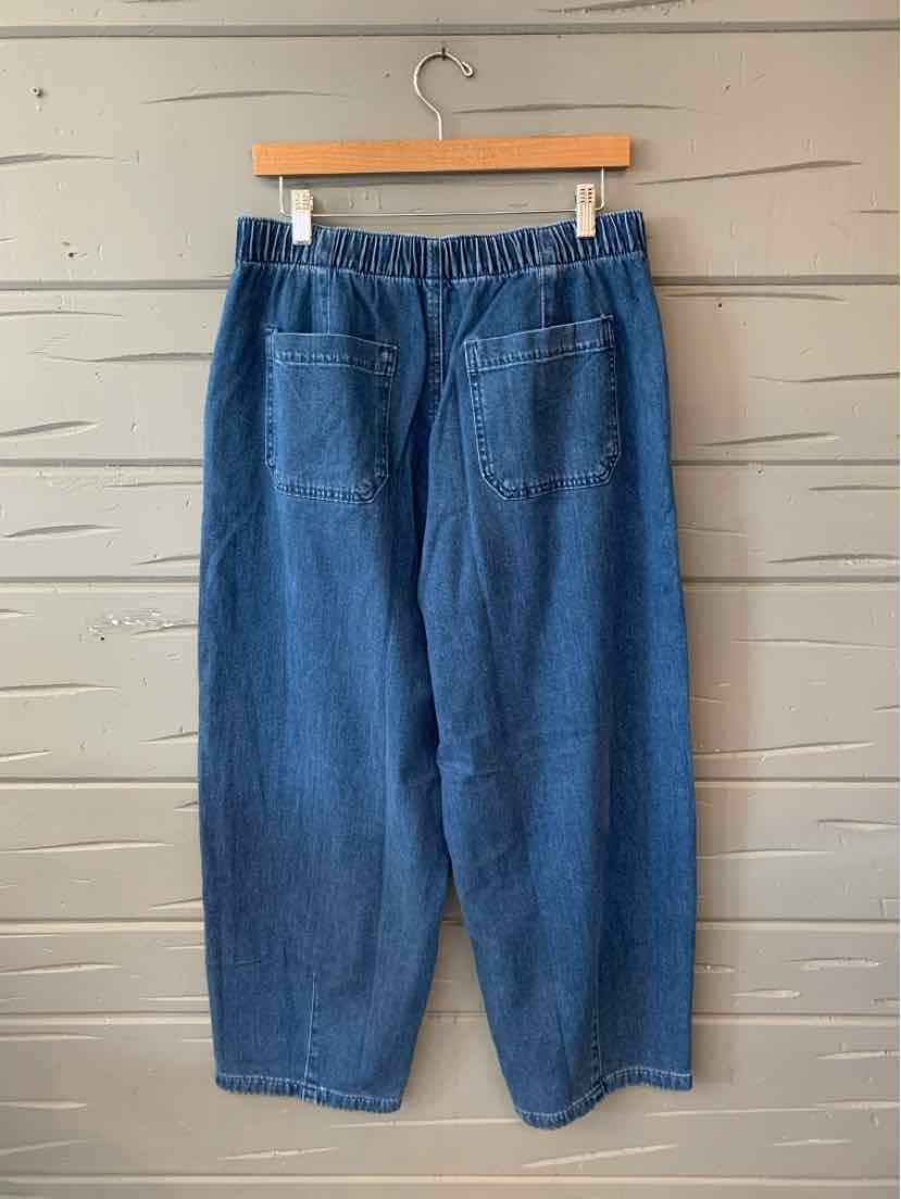 Mid-blue denim jogger pants with elastic waistband and two back patch pockets.