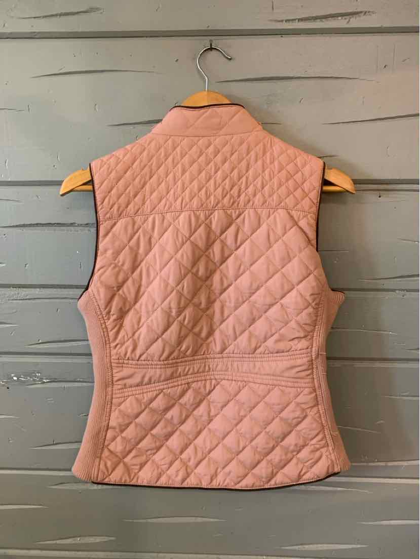 Mauve quilted sleeveless vest with diamond and horizontal stitching, fitted waist, hanging on wooden hanger.