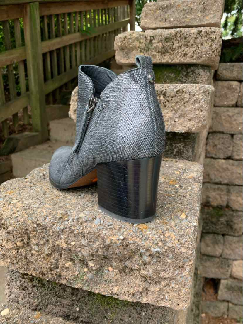 Metallic silver ankle boot with rounded toe, side zipper, and stacked block heel.