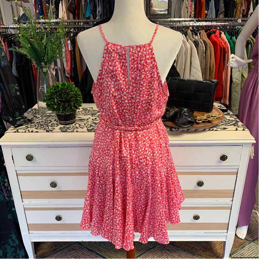 Pink sleeveless dress with white cheetah print and a cinched waist displayed on a mannequin.