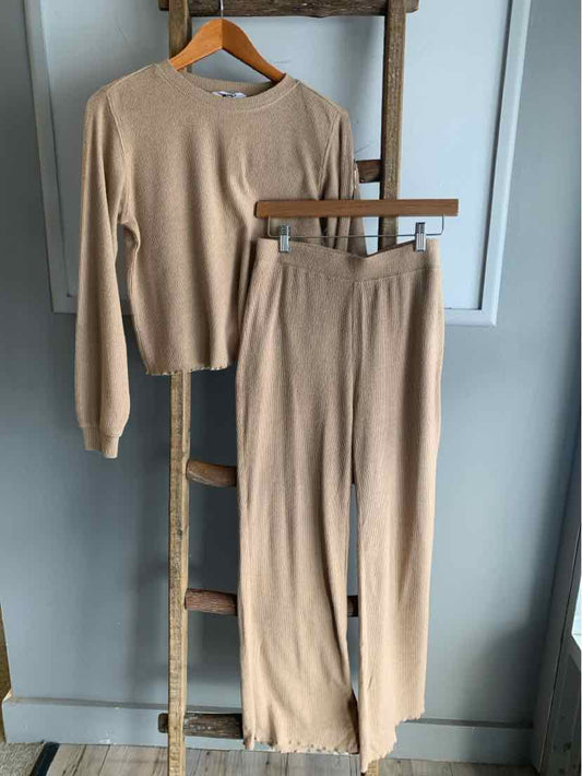 Tan long-sleeve cropped knit sweater with matching high-waist wide-leg knit pants.