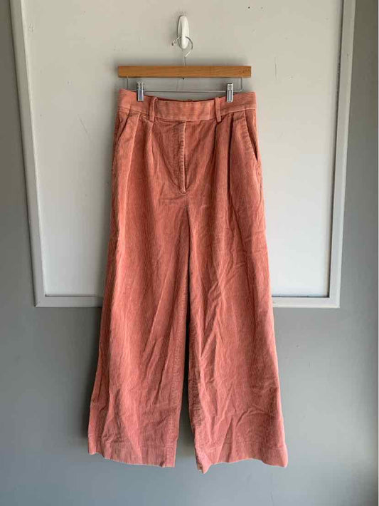 Wide-leg pink corduroy pants with pleated front and side pockets, size 8.