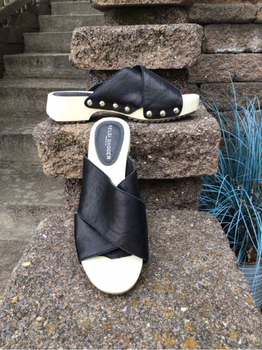 Black leather slide sandals with crisscross straps and gold studs, size 6.5, white sole.