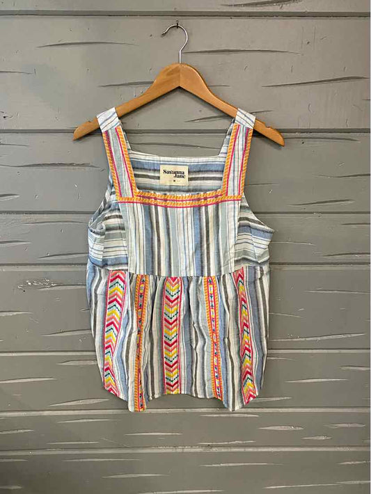 Sleeveless blouse with multicolored vertical stripes and chevron patterns in blue, orange, and pink tones.
