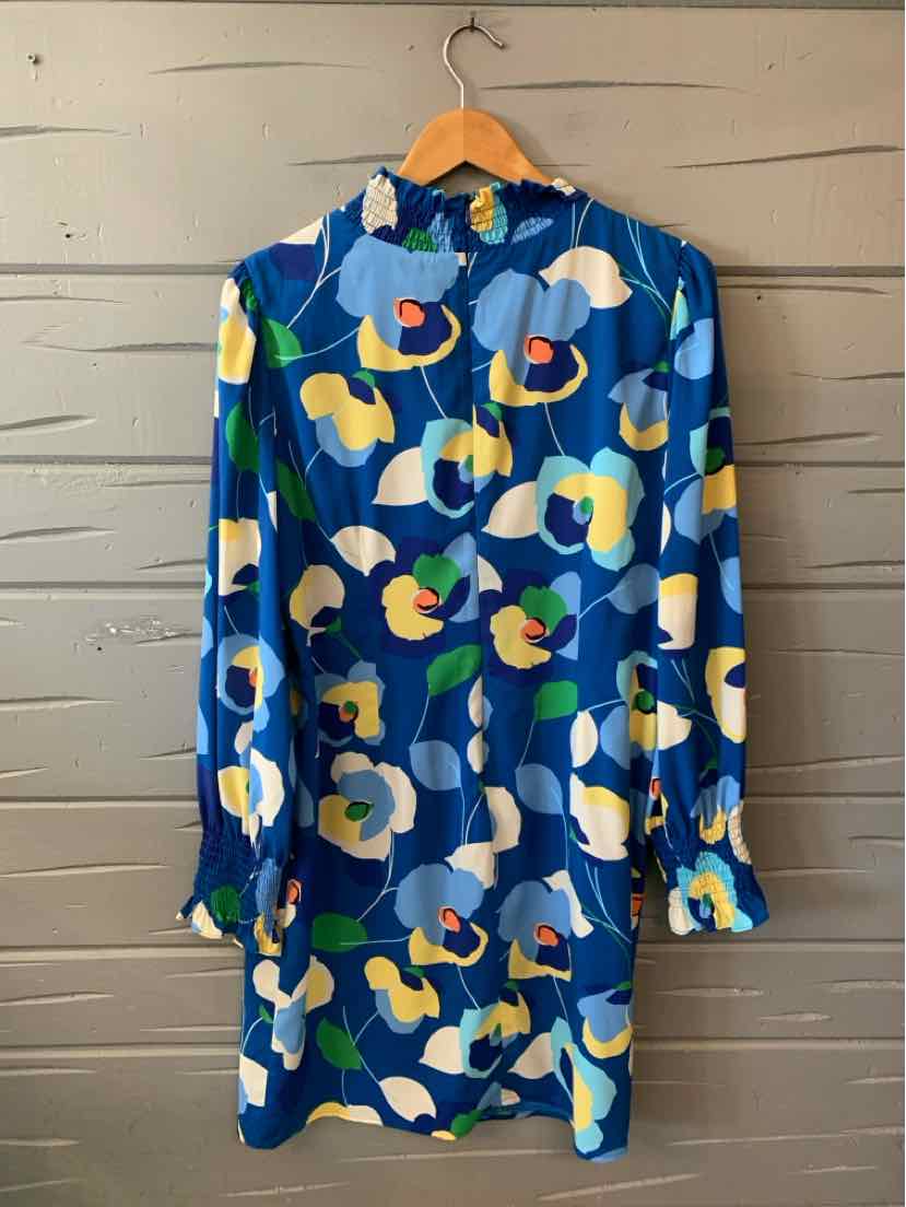 Blue long-sleeve mini dress with bold multicolored floral print and high neckline.