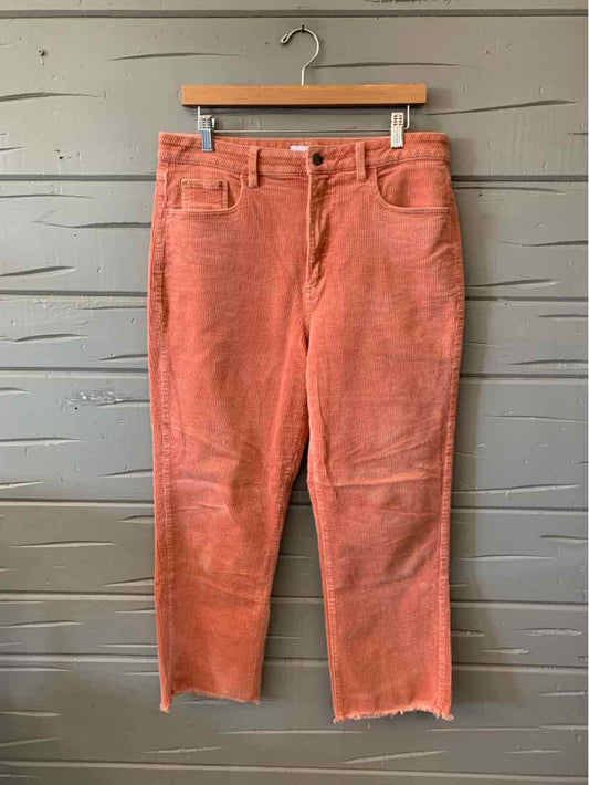 Coral pink corduroy pants with a button fly, front pockets, and cropped straight legs.