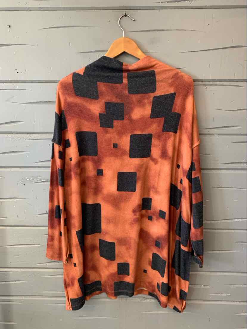 Orange long-sleeve tunic with an abstract black square pattern and draped hem.
