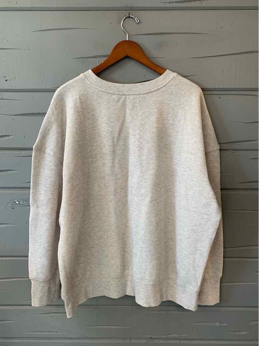 Women's heather gray crewneck sweater with long sleeves and a relaxed fit on a wooden hanger.