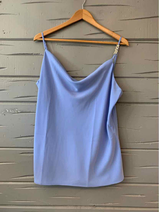 Light blue sleeveless satin camisole with draped neckline and thin chain straps on wooden hanger.