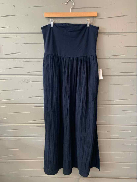 Navy blue strapless maxi dress with gathered waist and flowing skirt on wooden hanger.