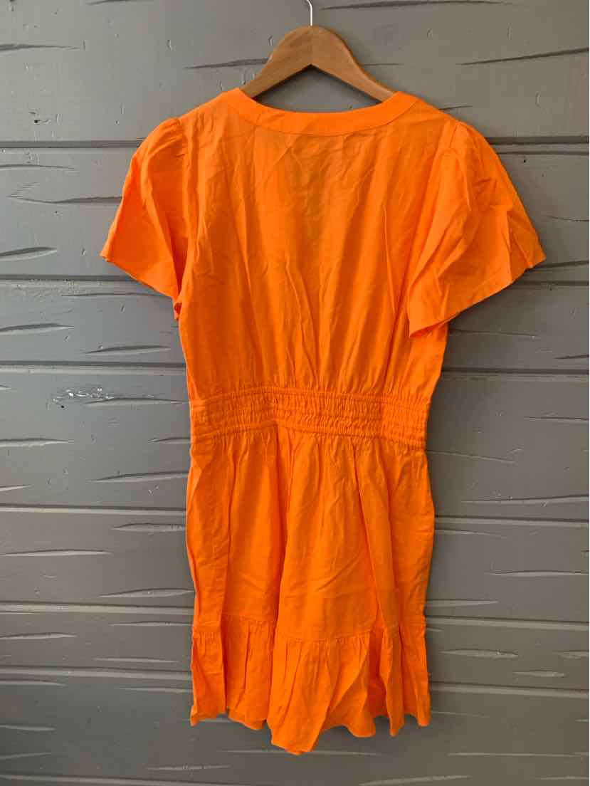 Orange short-sleeve romper with cinched waist and relaxed fit on wooden hanger.