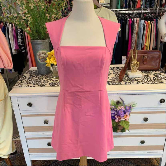Pink sleeveless square-neck mini dress with fitted waist and clean lines on mannequin.