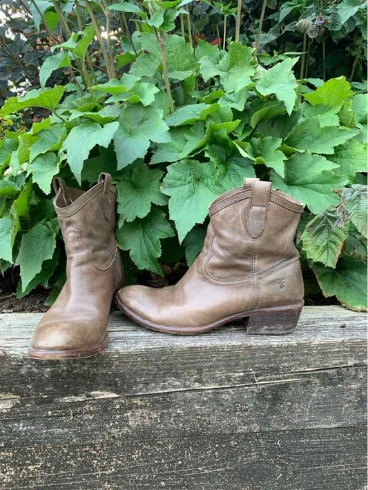 Brown leather mid-calf boots with a worn vintage look, rounded toes, and stacked heels.