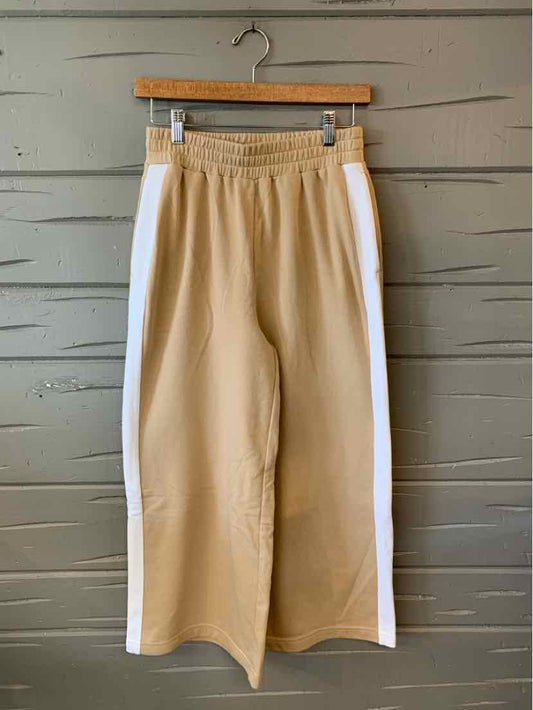Tan wide-leg pants with white side stripes and an elastic waistband in size XS hanging on wooden hanger.