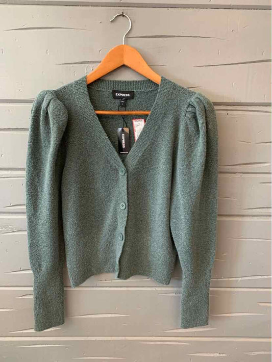 Green knit cardigan with puff shoulders and button front on wooden hanger.