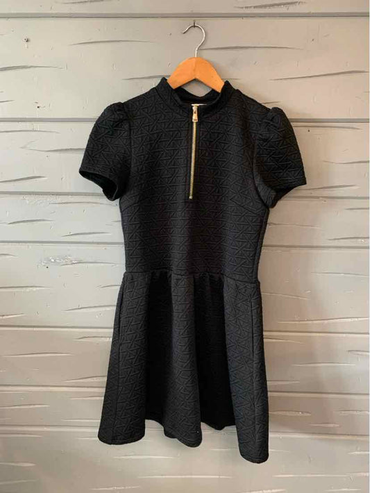 Black short-sleeve dress with puffed shoulders, fit-and-flare silhouette, and front zipper closure.