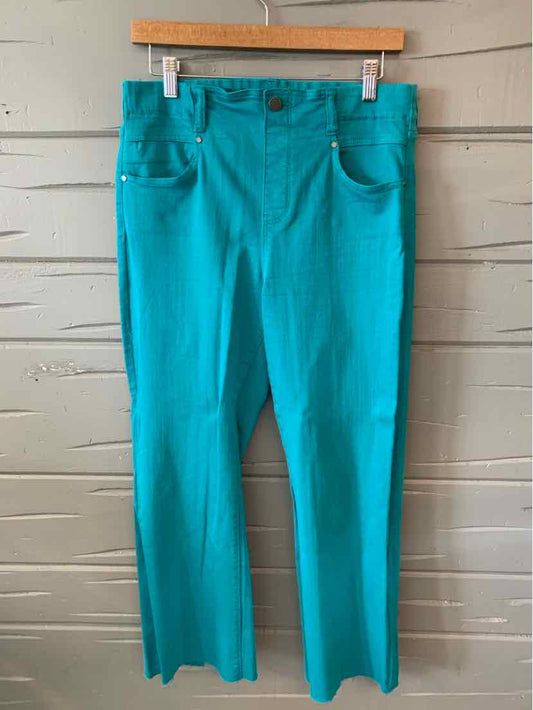 Teal straight-leg pants with front pockets and button closure hanging on wooden hanger.