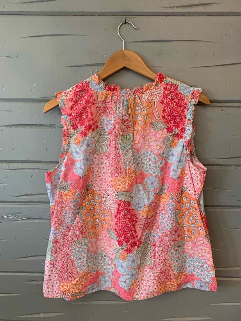 Sleeveless floral blouse in orange, pink, and white with gathered neckline on wooden hanger.