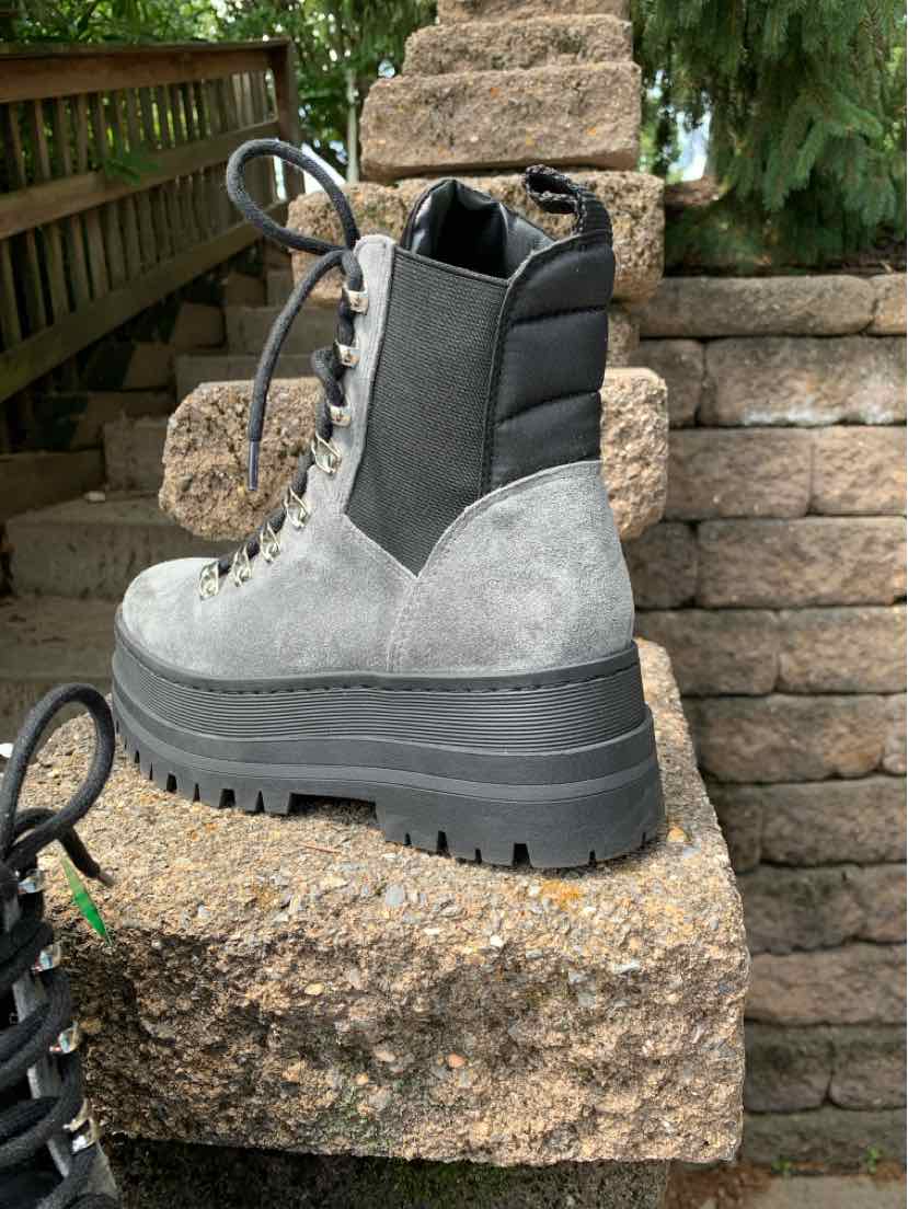 Gray suede lace-up boot with black padded collar and chunky lug sole, size 5.5.