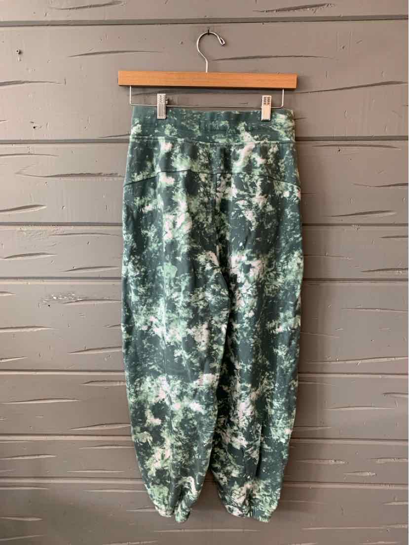 Green and cream tie-dyed jogger pants with elastic waistband and cuffs, size 6.