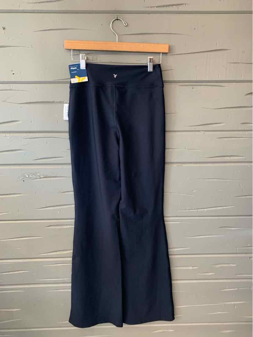 Dark navy Old Navy women’s trousers with a straight, slightly flared leg, hanging from a wooden clip hanger.