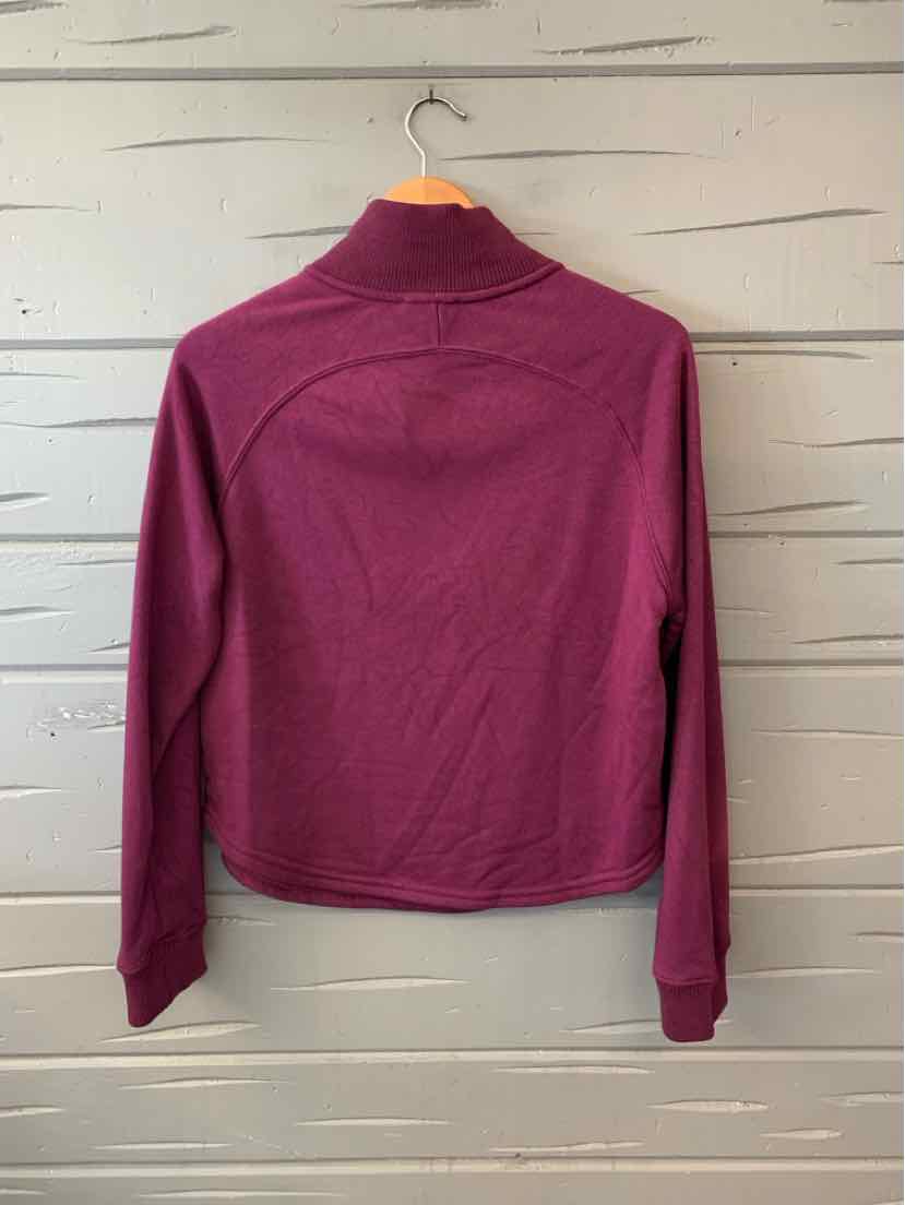 Women’s solid plum long-sleeve top with a high neckline and gently curved hem, shown from the back.