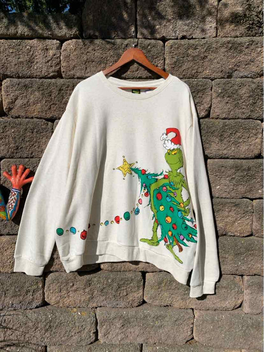White long-sleeve Grinch T-shirt with a colorful Christmas tree graphic and holiday accents.