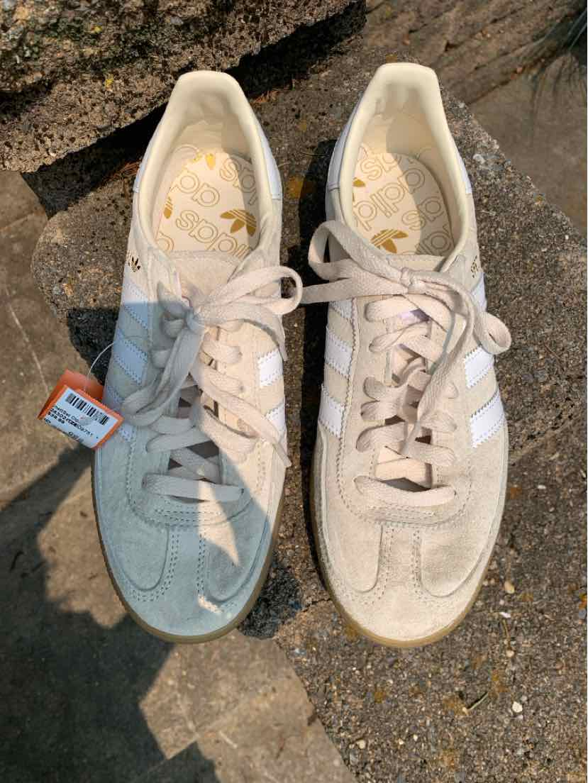 Pair of tan Adidas sneakers in size 9 with white stripes, suede material, and laces, worn and scuffed.