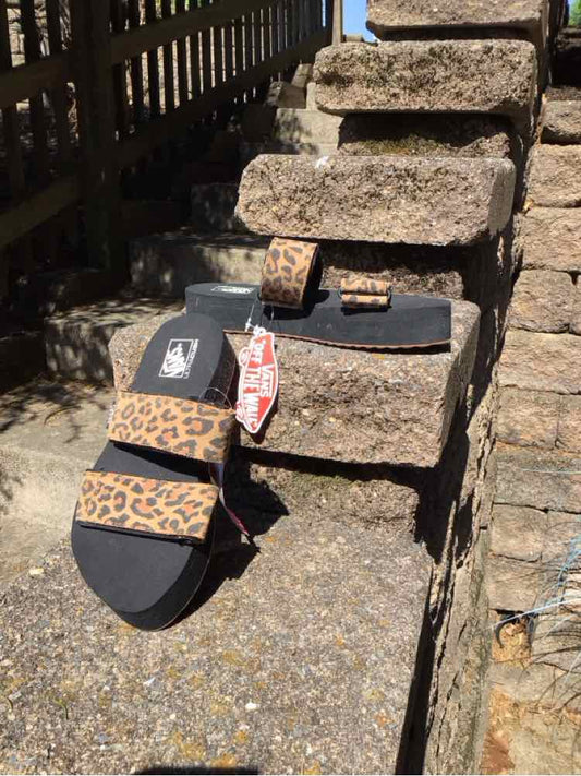 Tan Vans women's sandal with black sole and cheetah print straps, size 6.