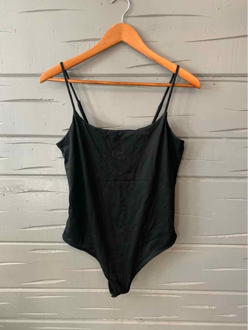 Black spaghetti strap bodysuit with scoop neckline and smooth fabric on wooden hanger.