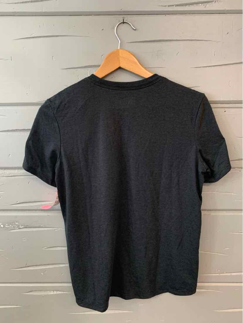 Black short-sleeve crew neck t-shirt in size small hanging on wooden hanger against gray wall.