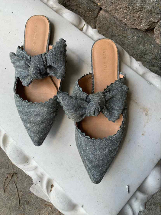 Gray fabric pointed-toe slip-on flats with large decorative bows and scalloped edges.