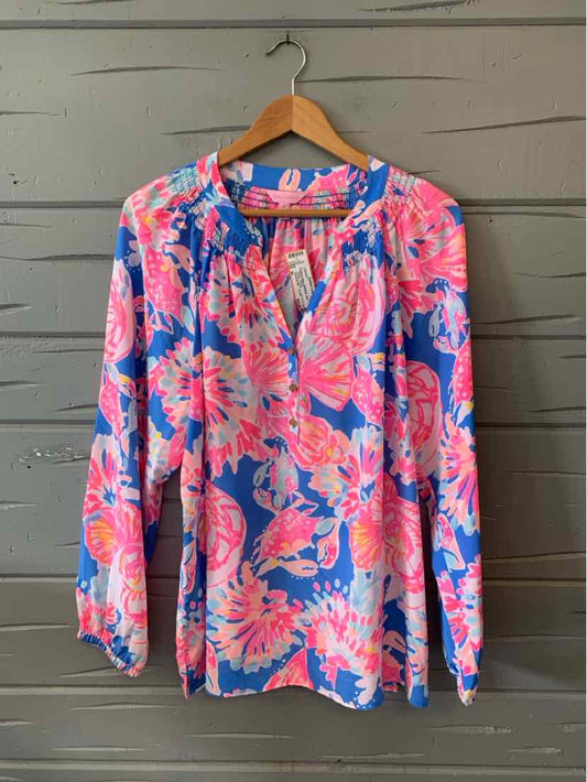 Long-sleeve floral blouse in pink, blue, and coral with a V-neck and lightweight fabric.